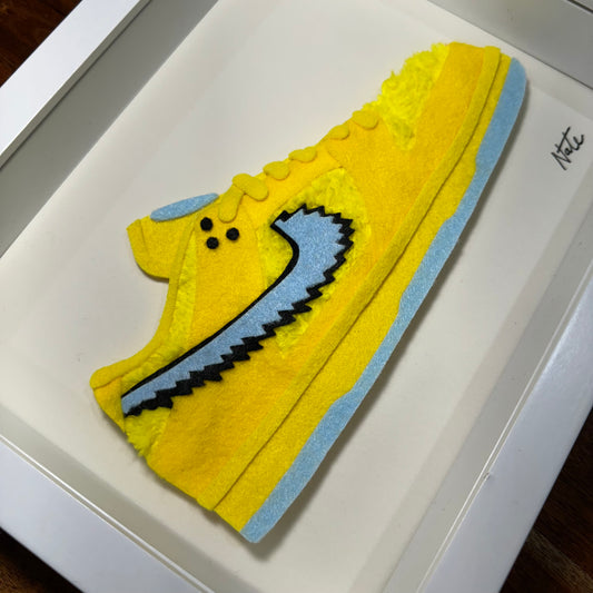 Handmade felt sneaker art with yellow bear faux fur accents, framed