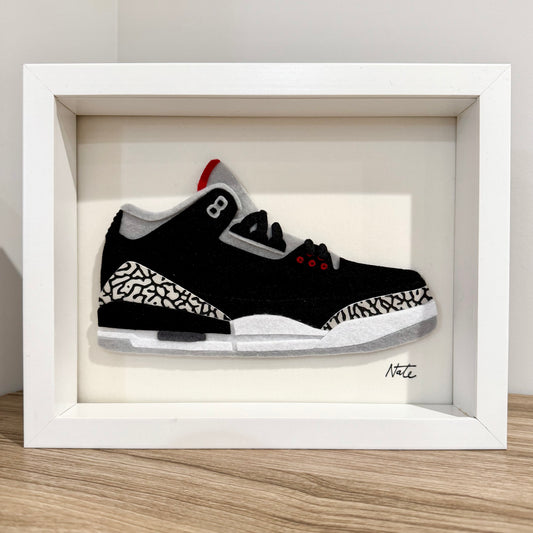 Handmade felt sneaker art with black elephant print accents, framed