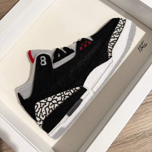 Handmade felt sneaker art with black elephant print accents, framed