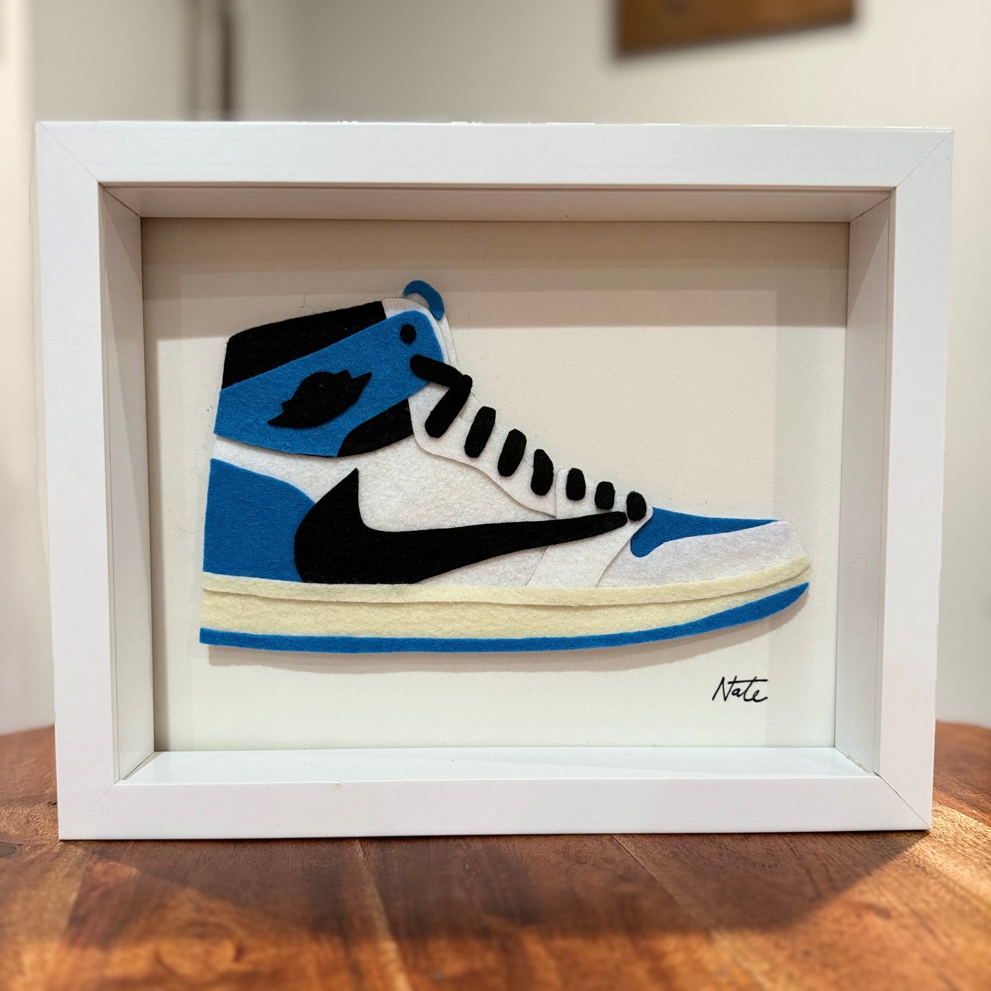Handmade felt sneaker art in blue and black high-top colorway, framed