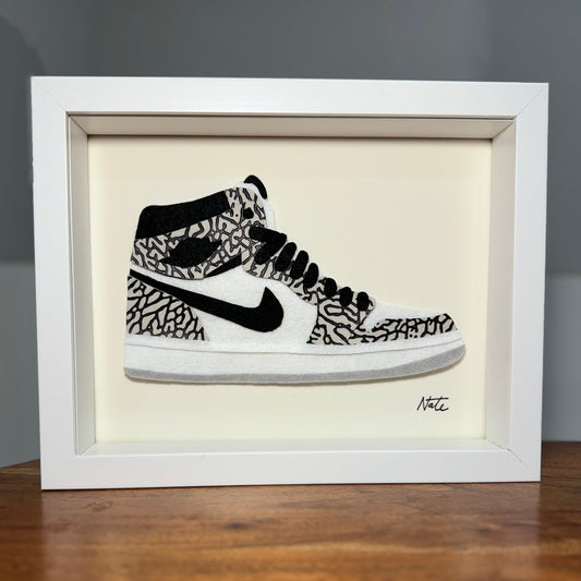 Handmade felt sneaker art with elephant print accents, framed