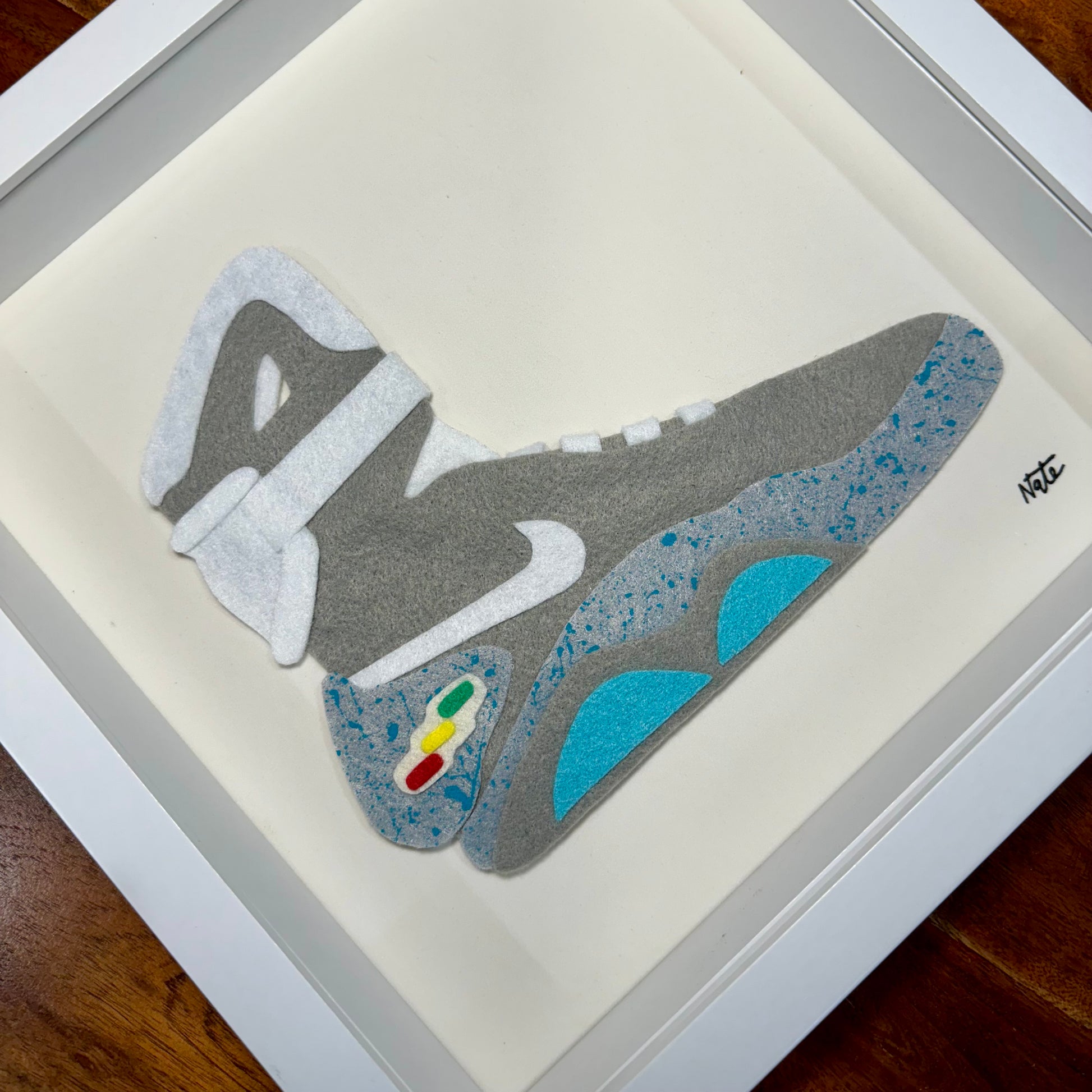 Handmade felt sneaker art in futuristic high-top colorway, framed