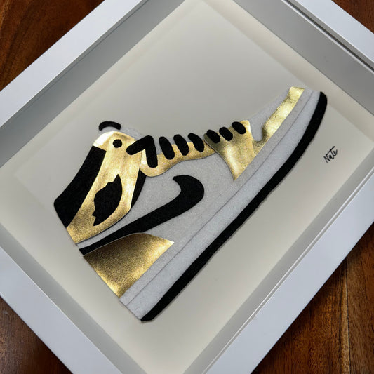 Handmade felt sneaker art in gold high-top colorway with black and white accents, framed