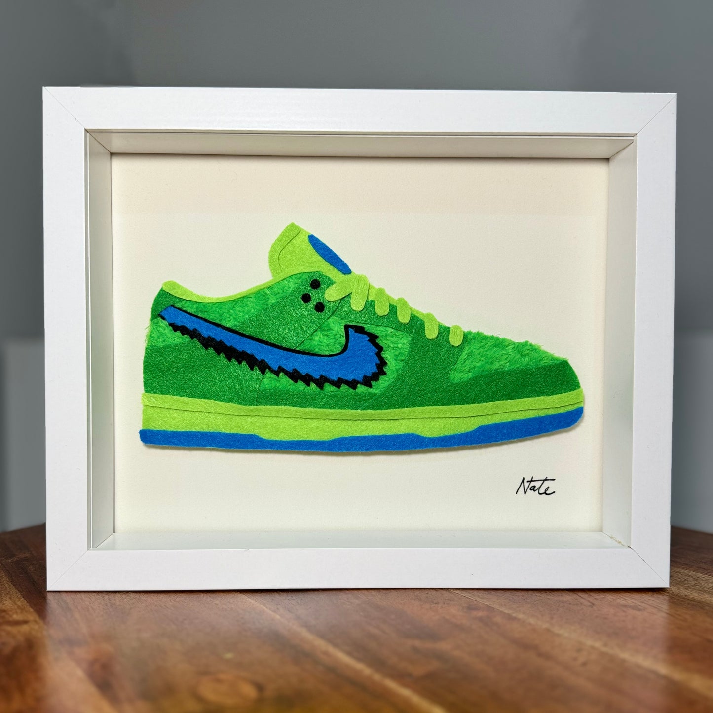 Handmade felt sneaker art with green bear faux fur accents, framed