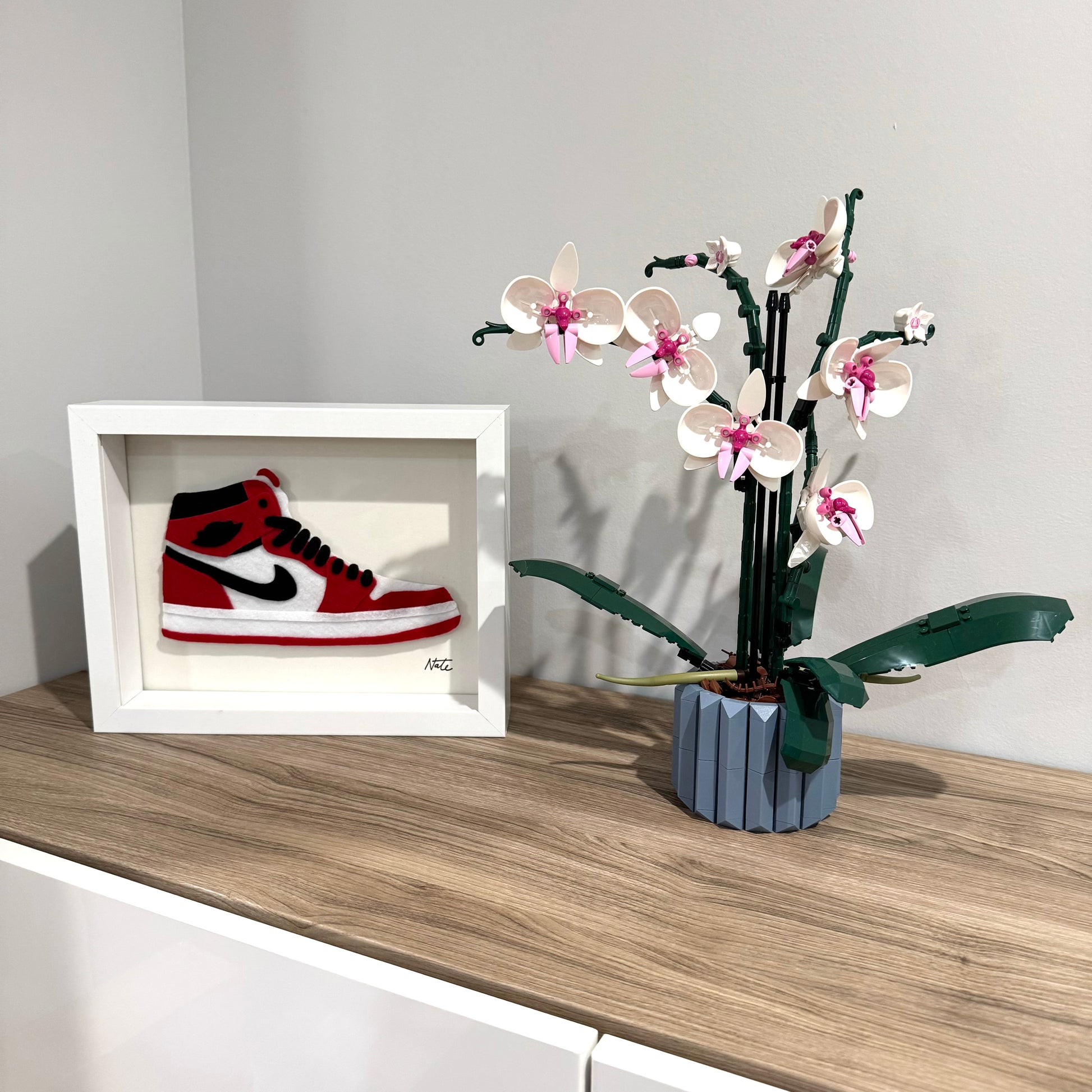 Handmade felt sneaker art in red and black high-top colorway, framed
