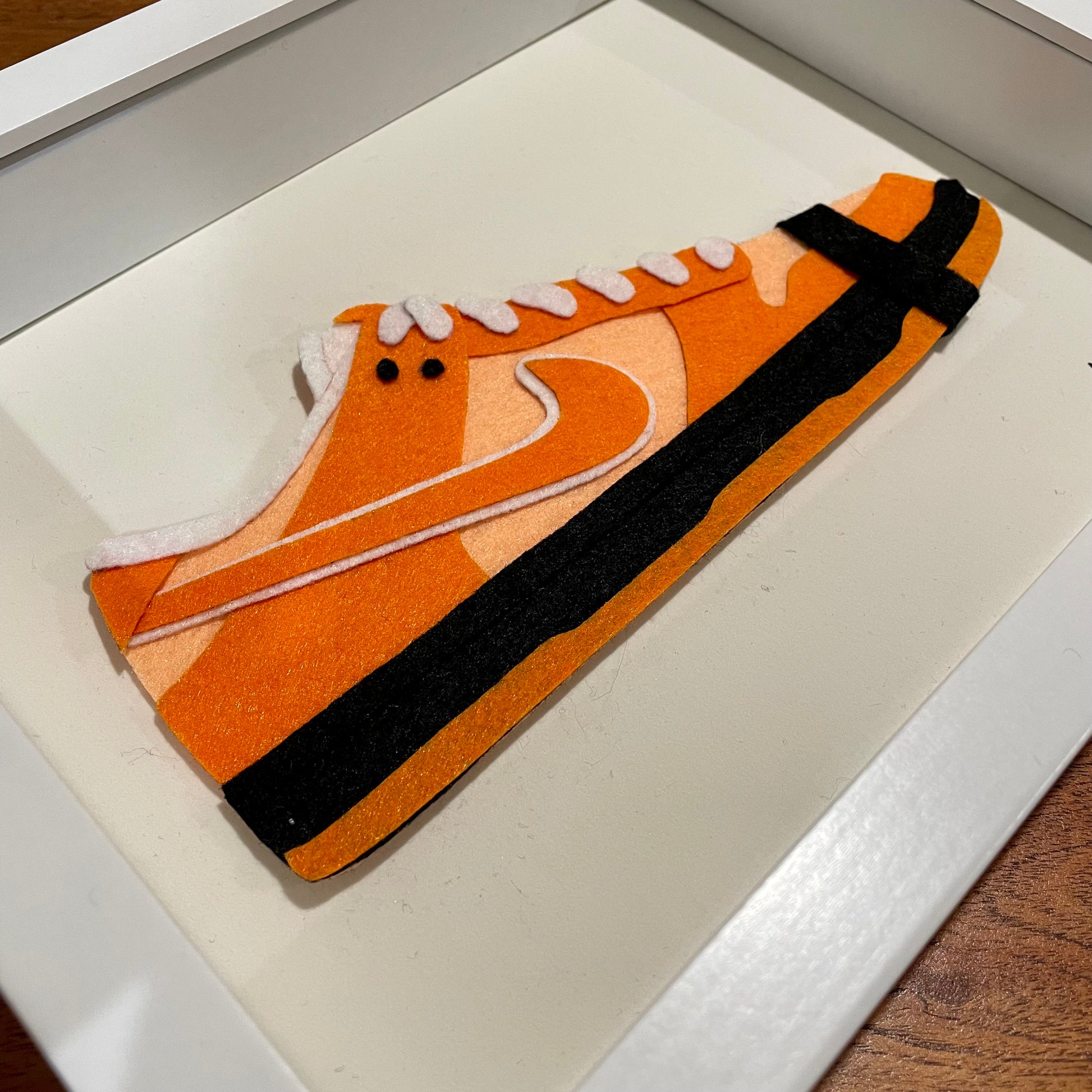 Handmade felt sneaker art in orange lobster low-top colorway, framed