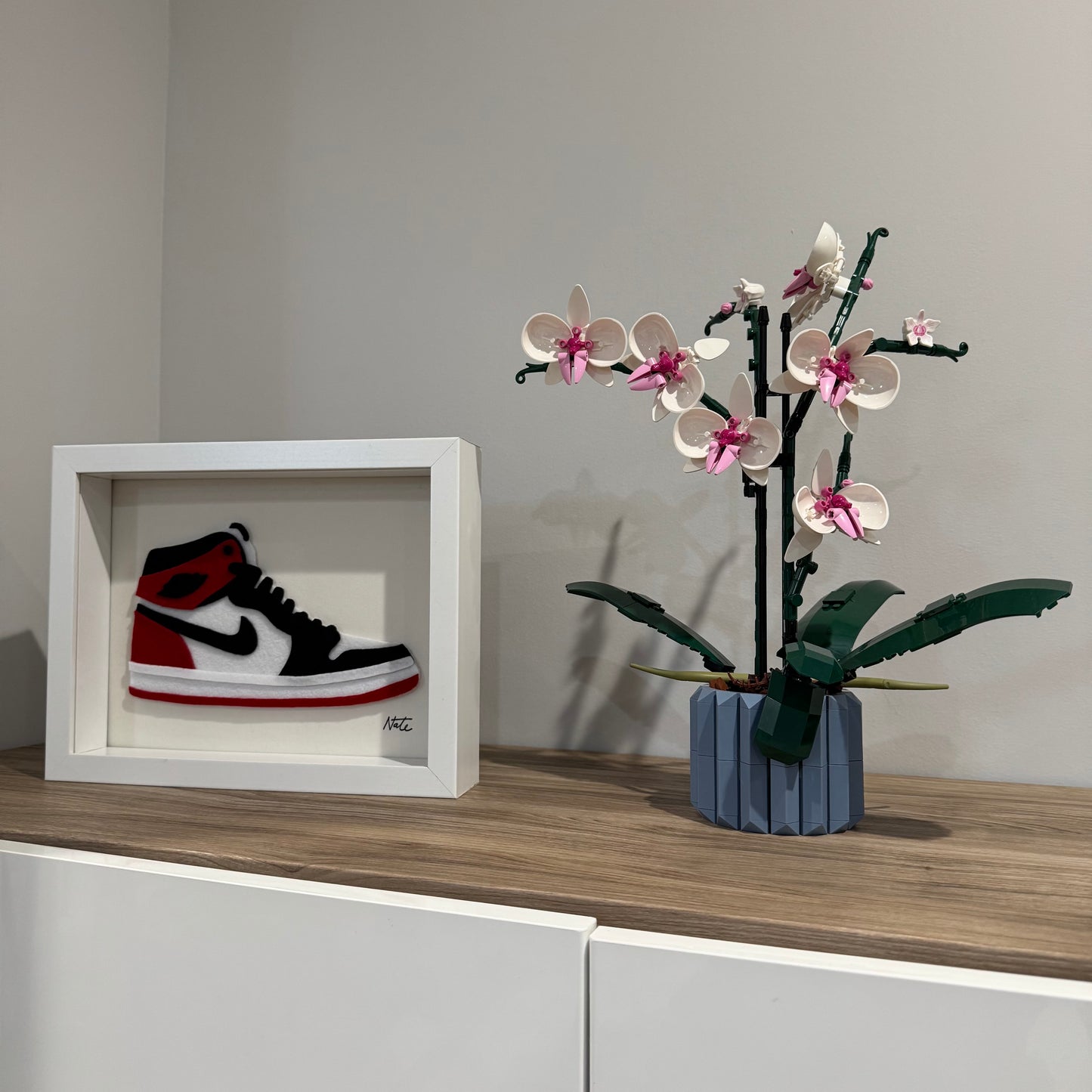 Handmade felt sneaker art in red and black high-top colorway, framed