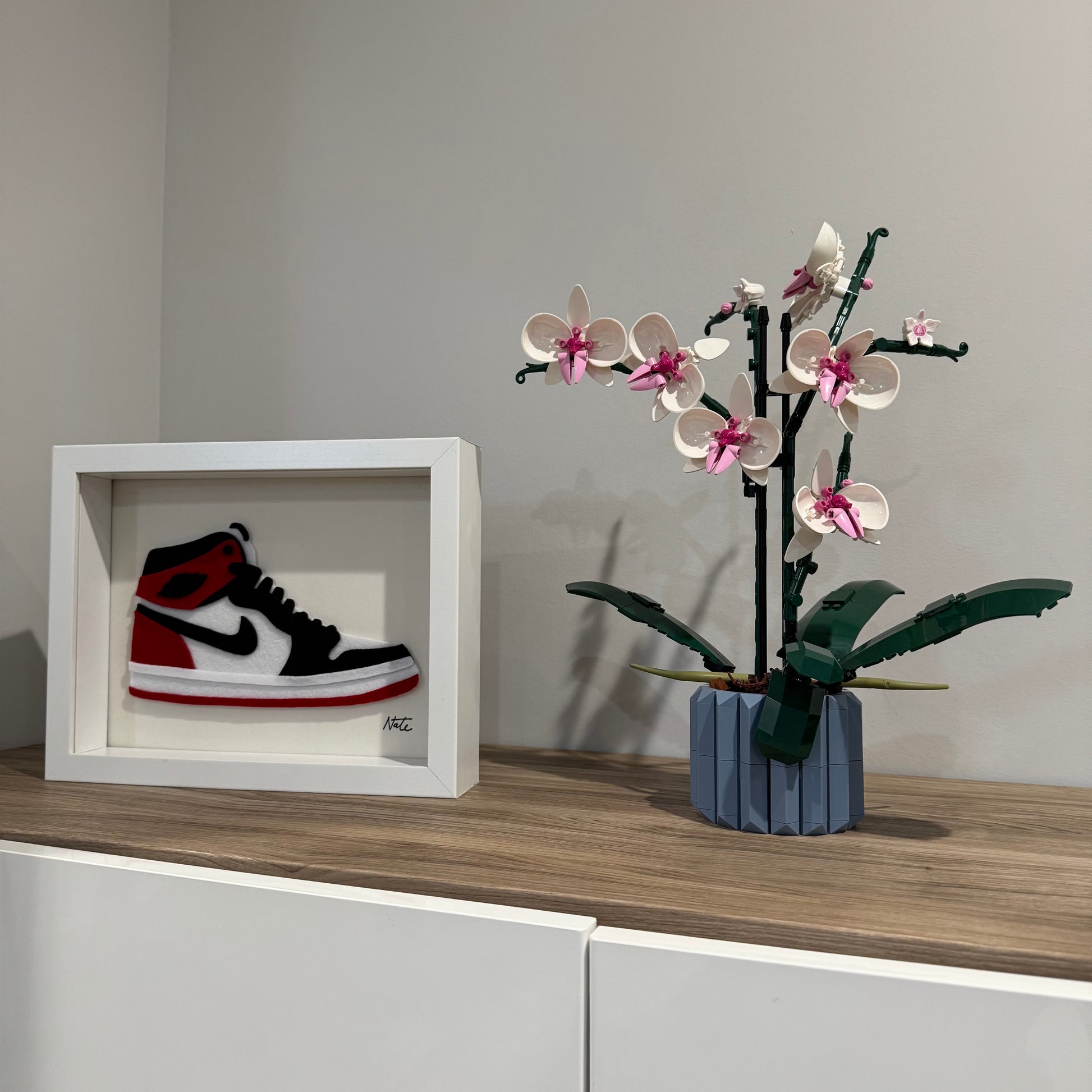 Handmade felt sneaker art in red and black high-top colorway, framed
