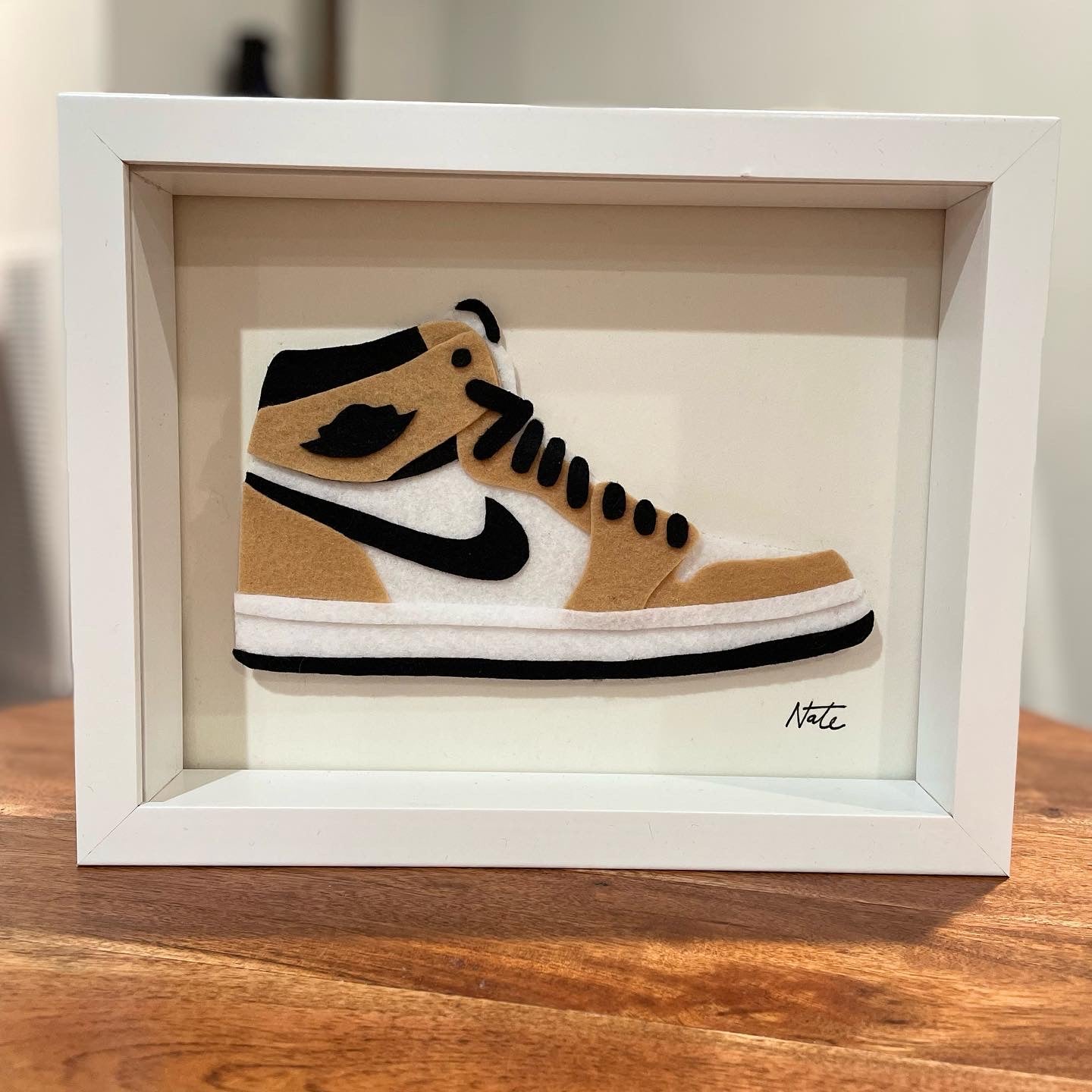 Handmade felt sneaker art in tan high-top colorway, framed