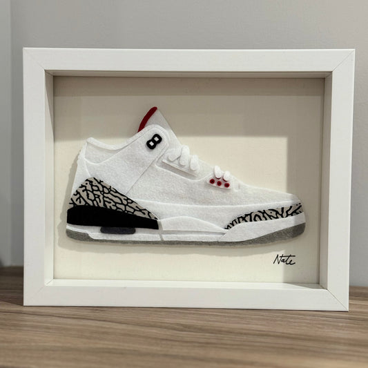 Handmade felt sneaker art with white elephant print accents, framed